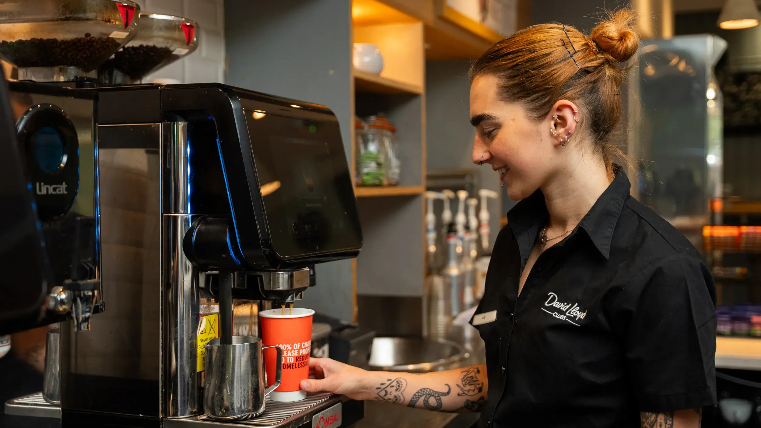 A woman makes a coffee with a coffee machine