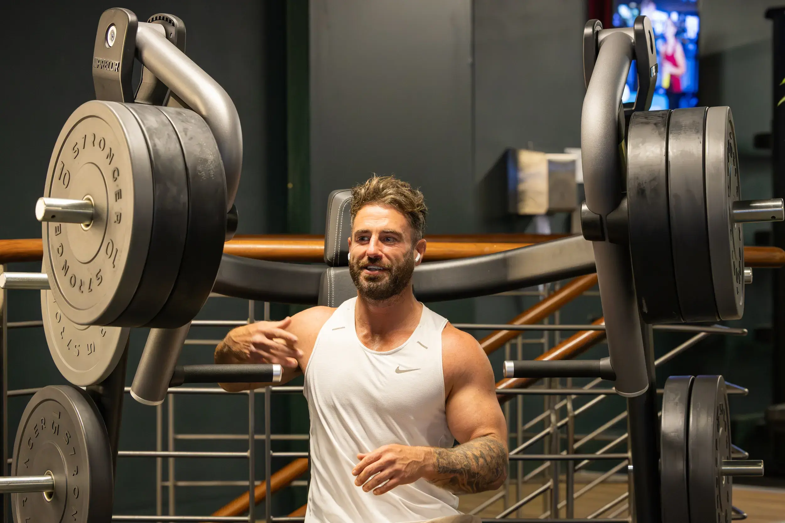 A man standing next to weights 