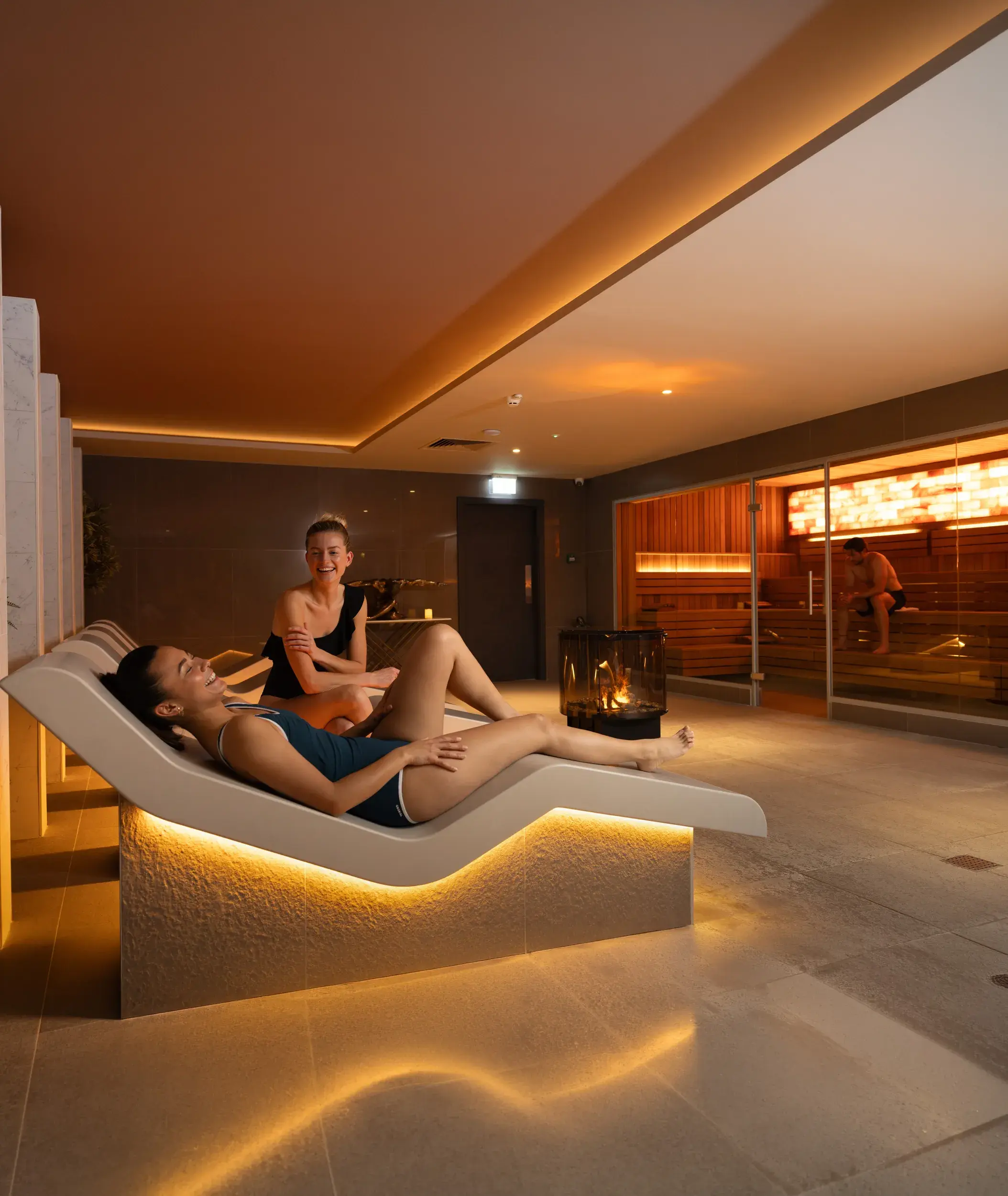 People relaxing on the heated loungers