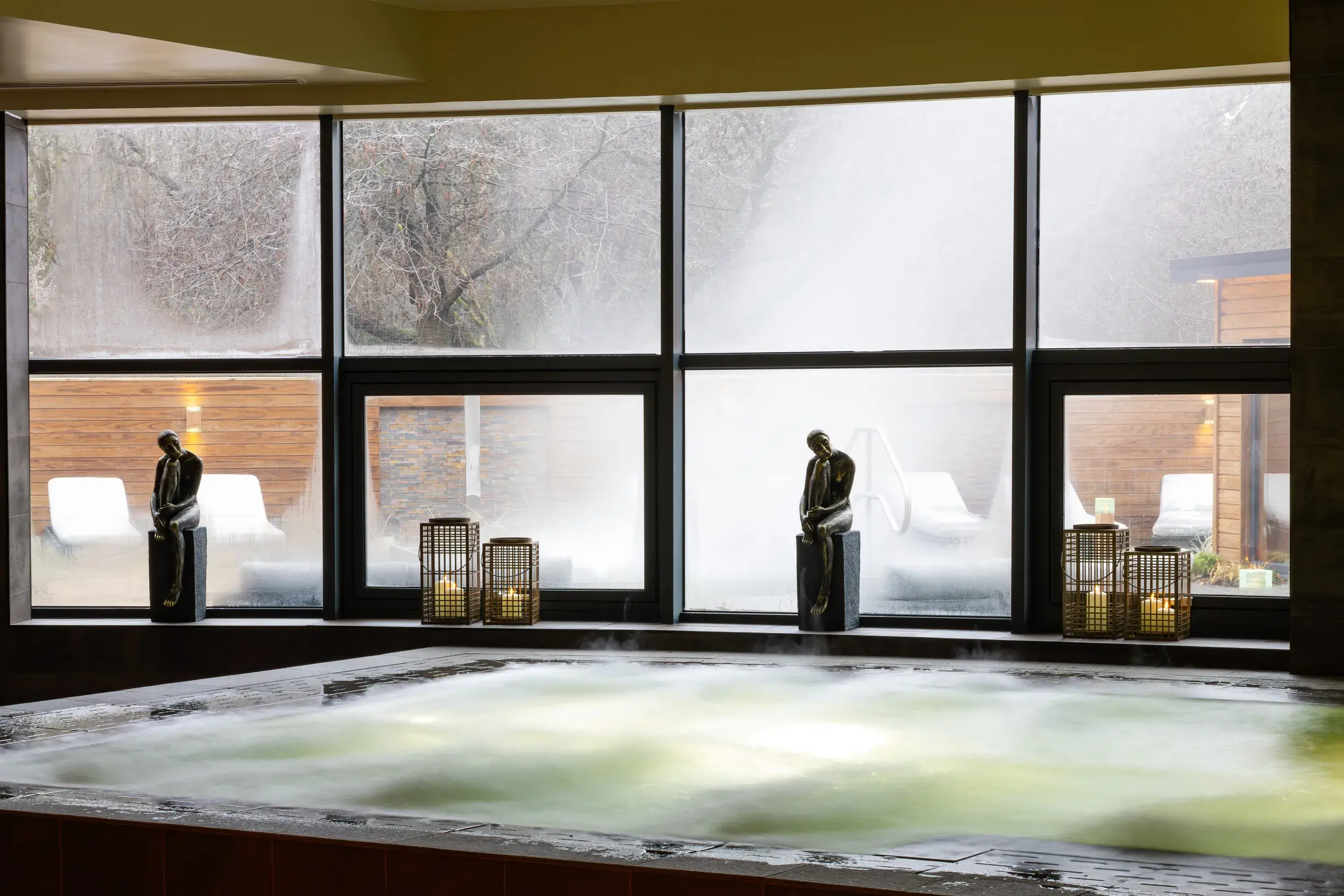 The indoor whirlpool in front of a large window