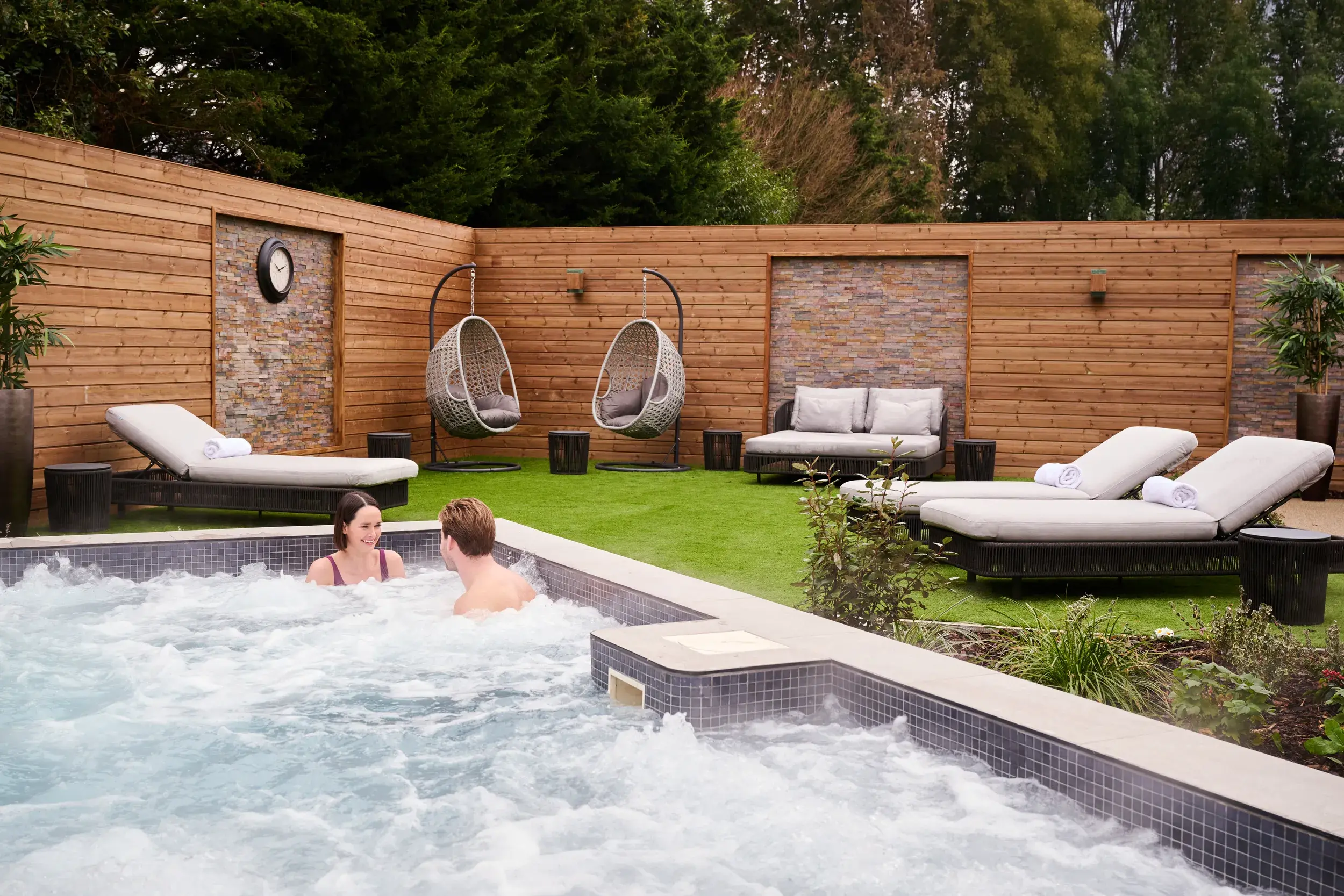 A man and a woman in the outdoor hydro pool