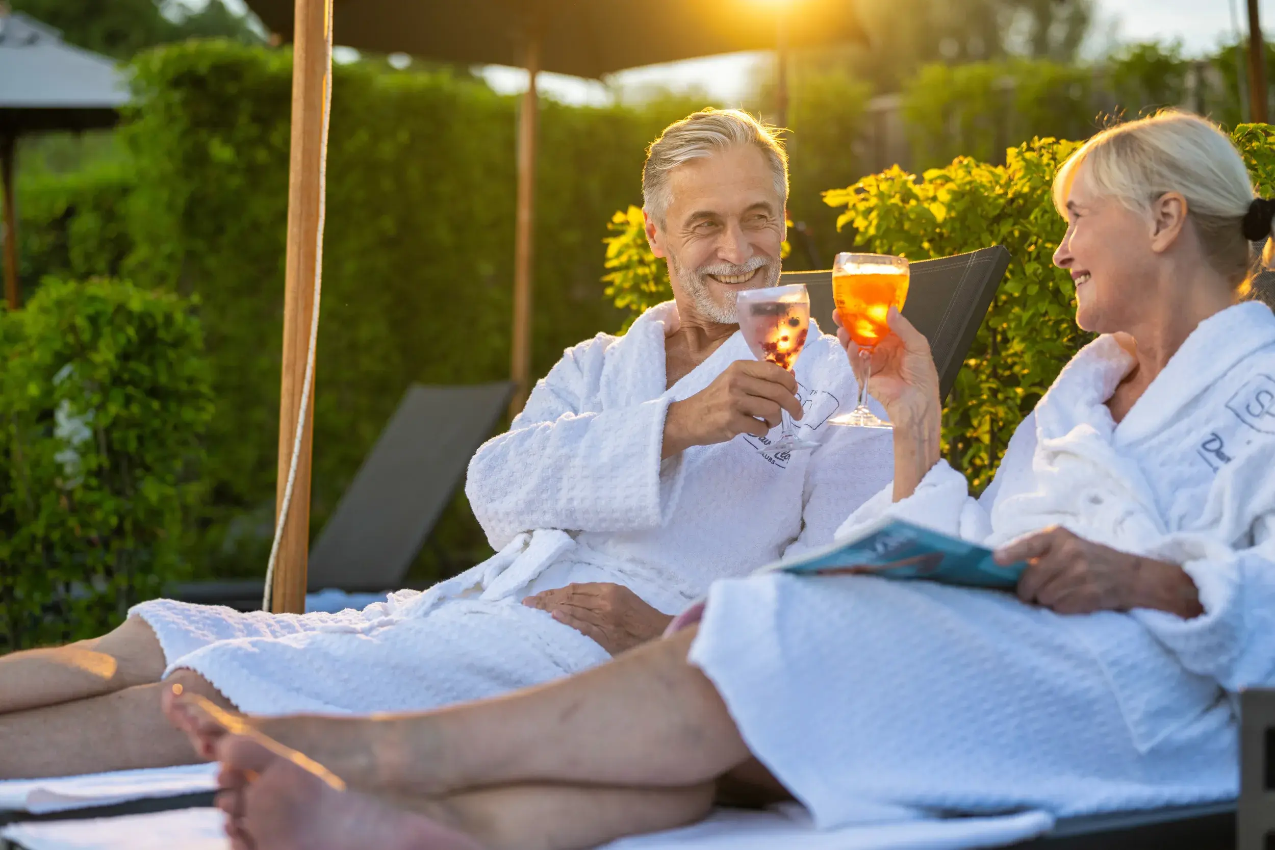 A man and a woman enjoying a drink on the outdoor terrace
