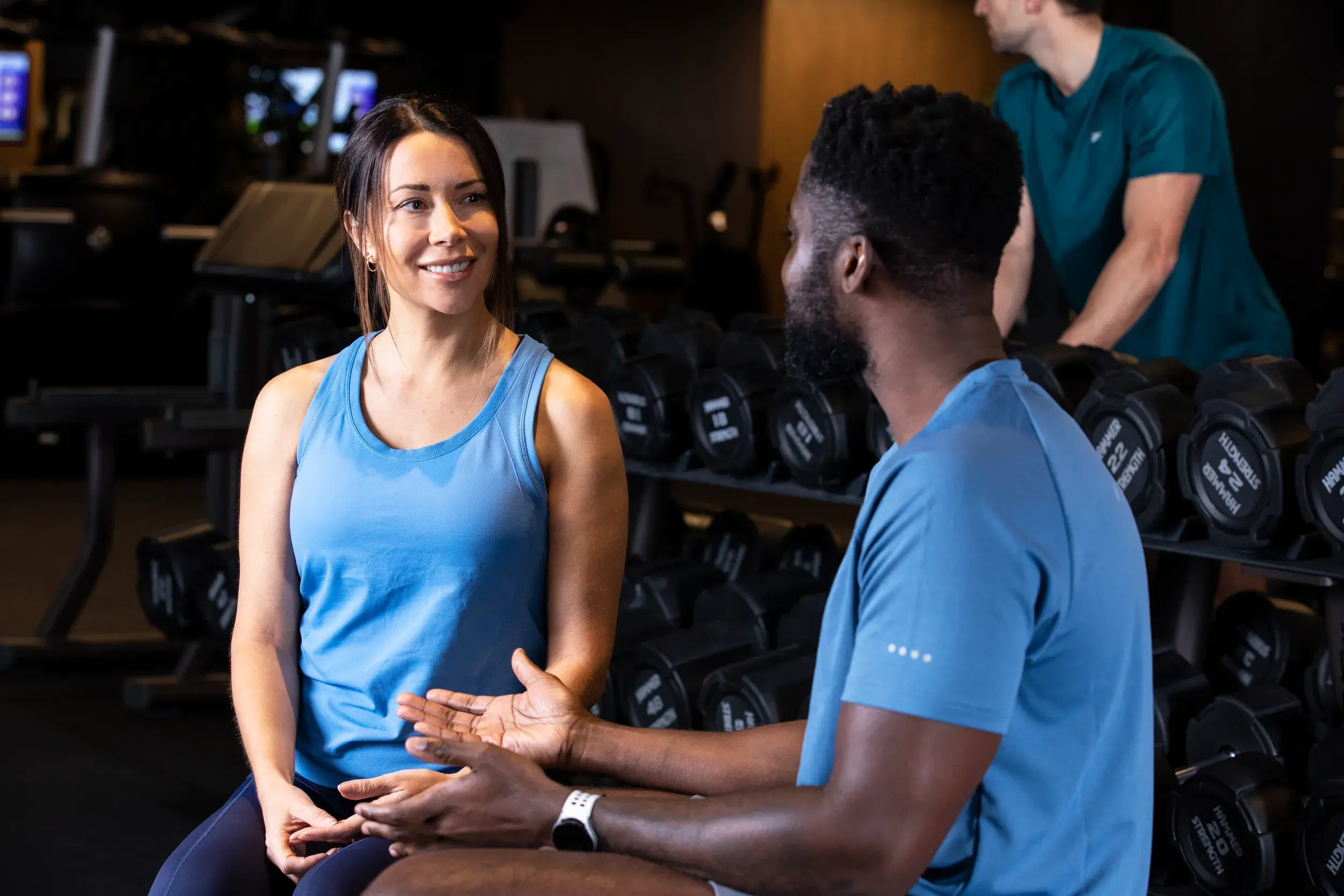 Woman talking to a man in the gym