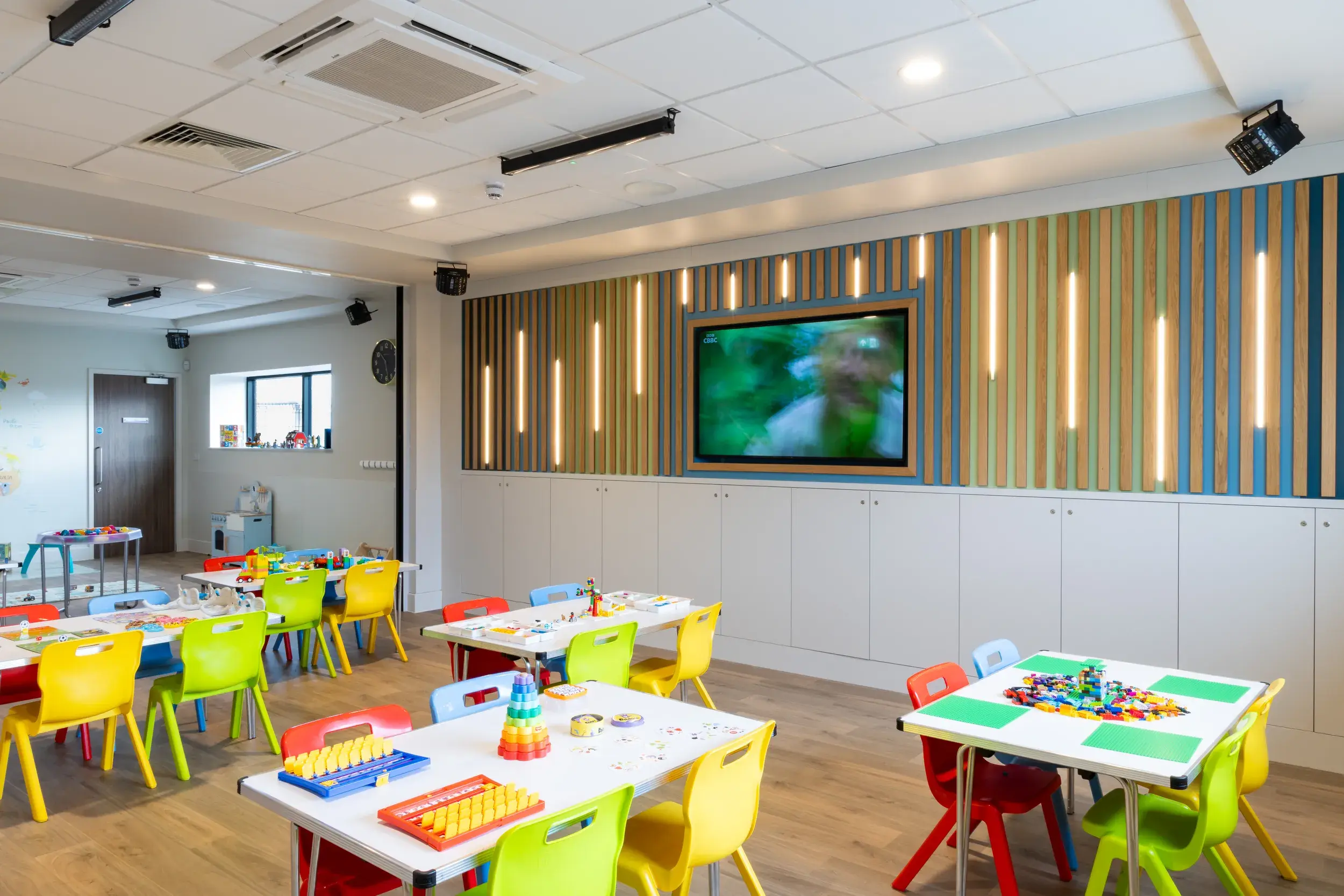 Children playing under a multicoloured tent