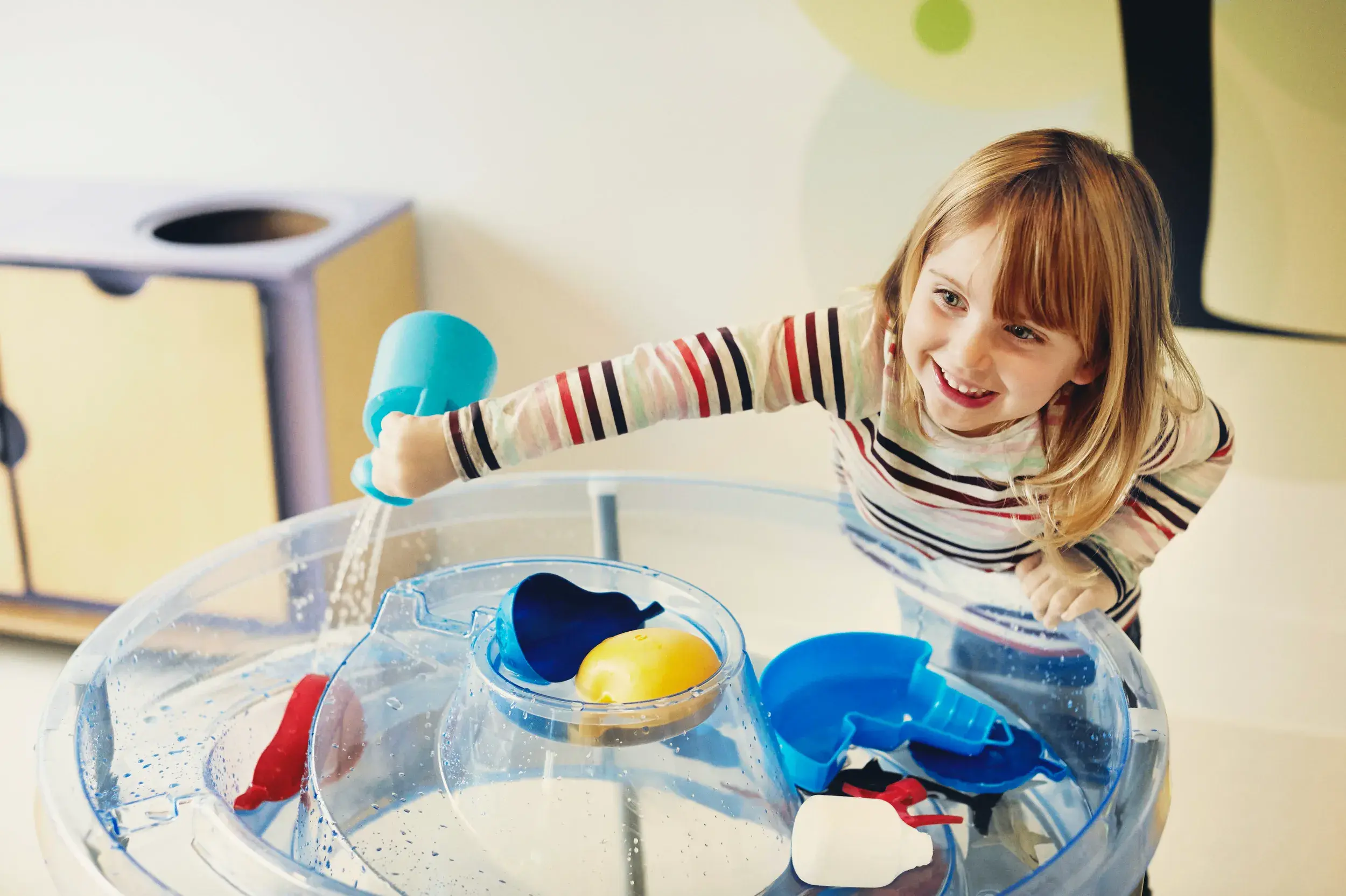 A DL Kids team member playing with a baby
