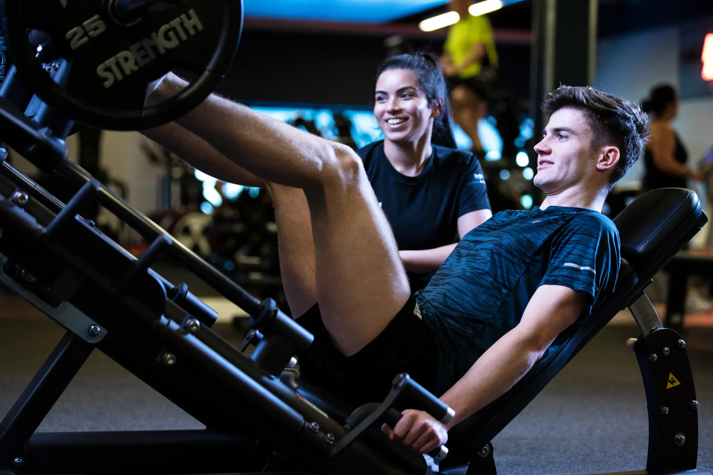 A personal trainer works with their client